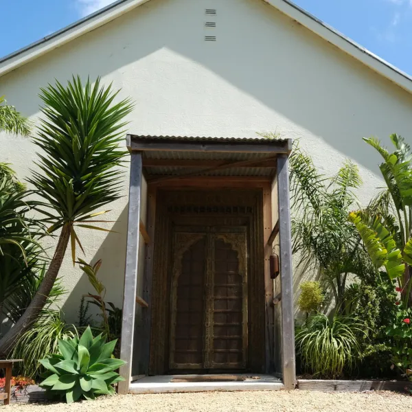 Nirranda Arts, featuring a white building with greenery at the entrance.