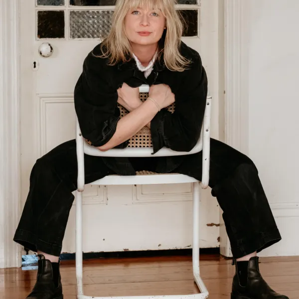Megan sitting backwards on a chair