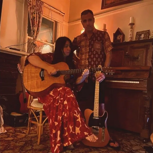 AURA RISING with acoustic guitar, in front of piano