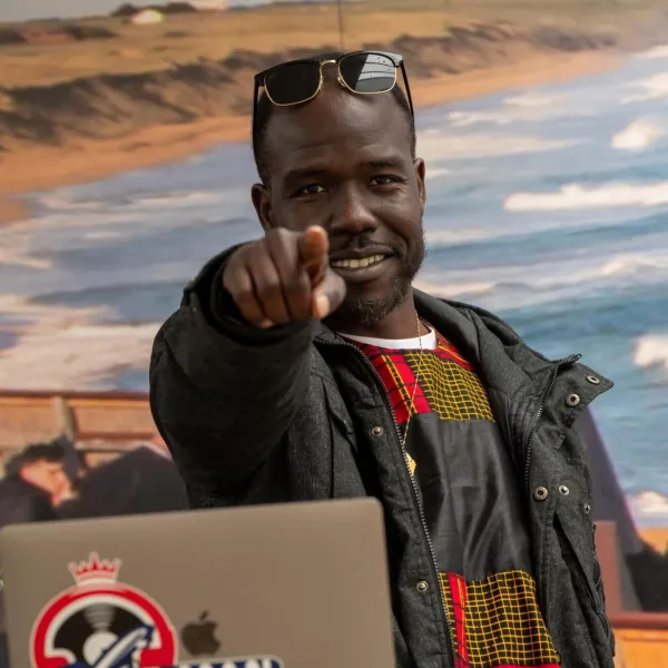 Dj E-Man playing in front of a beach 