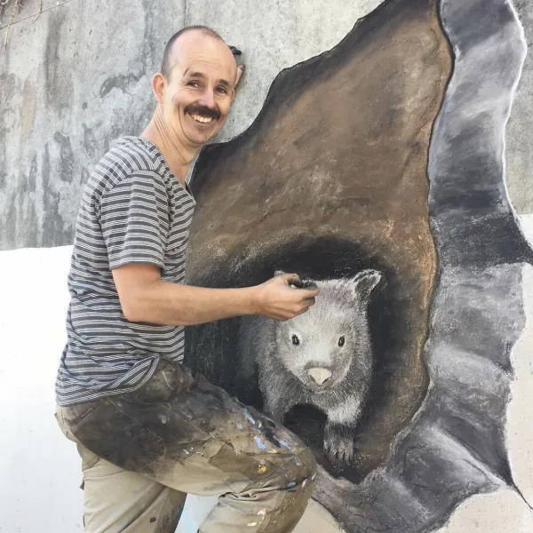Jimmy with his public mural of a wombat