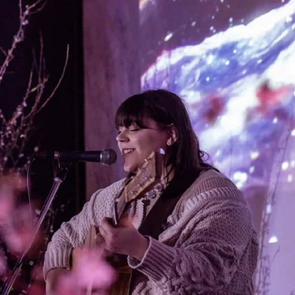 Female performer playing guitar
