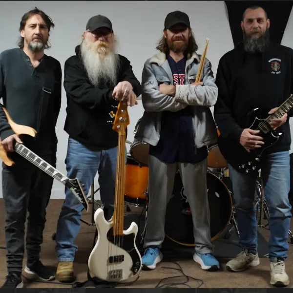 Four male musicians looking very rock n roll