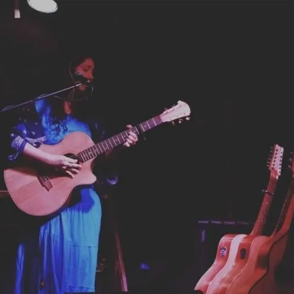 A female singer playing guitar