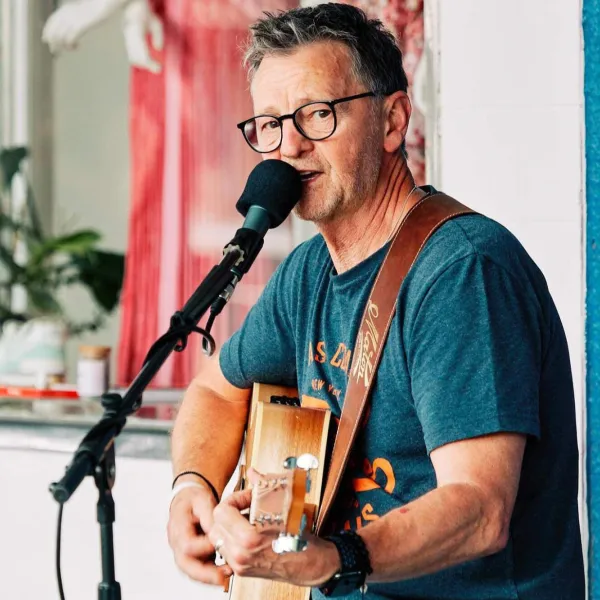 Male performer with guitar singing