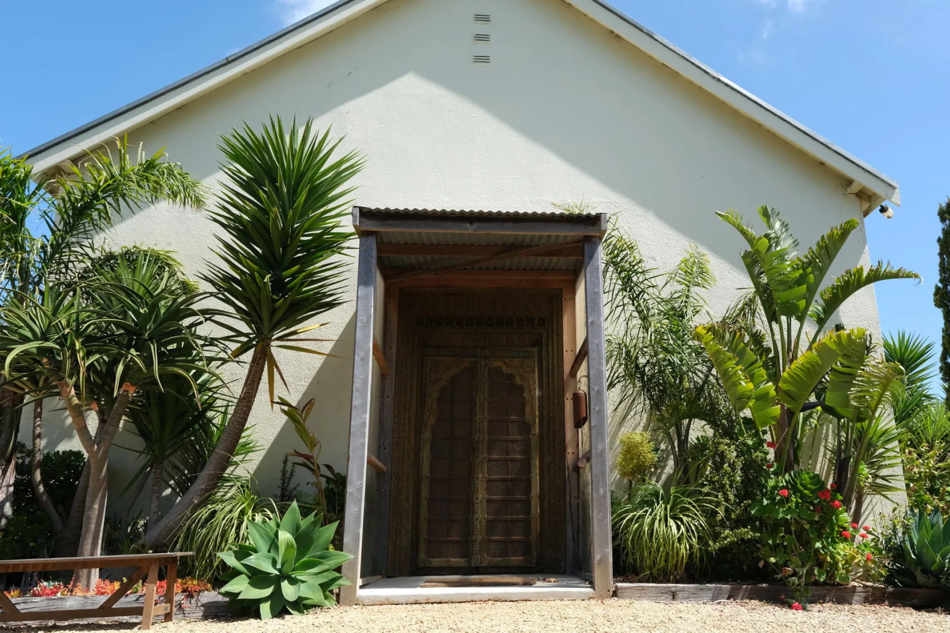 Nirranda Arts, featuring a white building with greenery at the entrance.