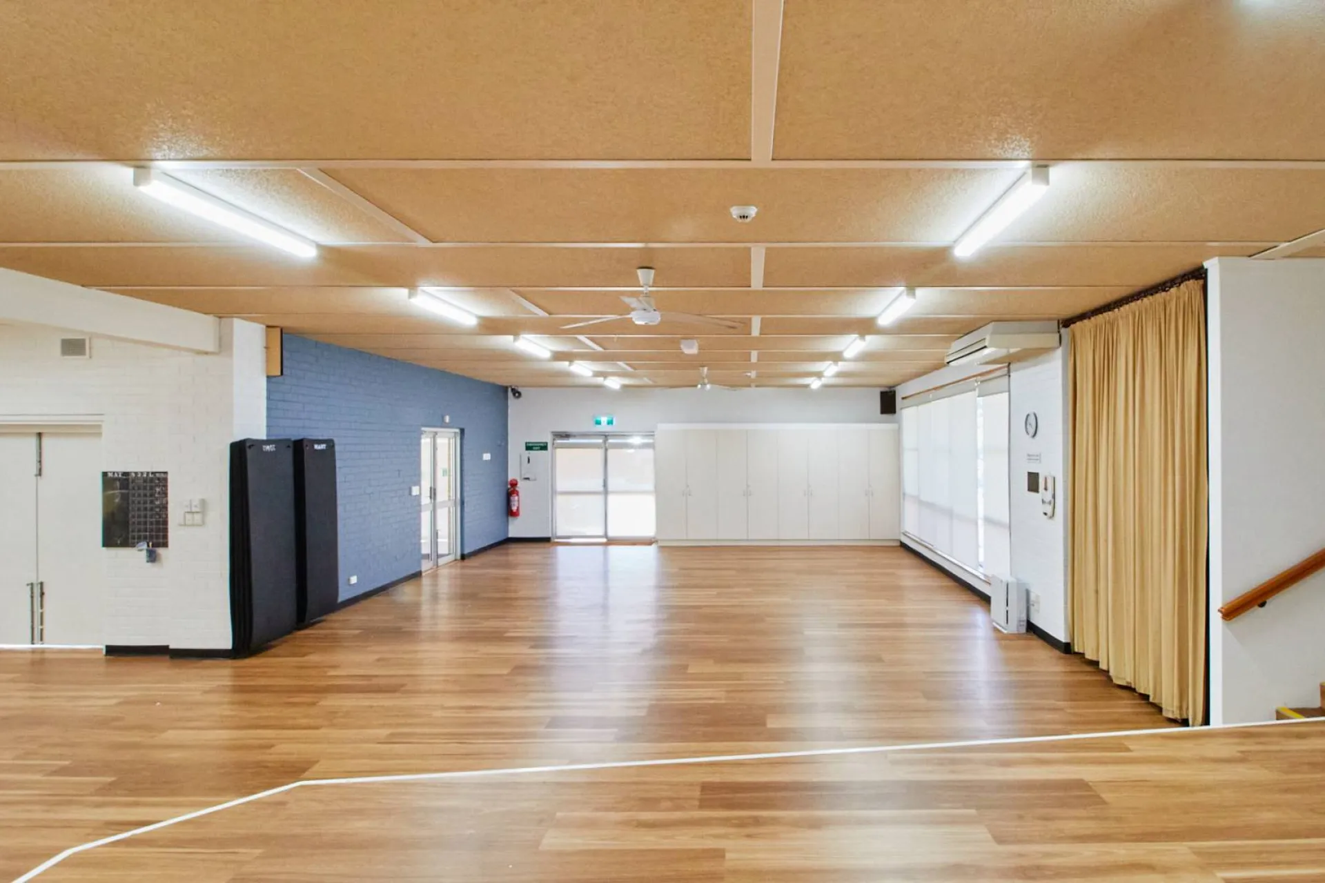 The recreation room at Archie Graham is a large, open space with polished floorboards.