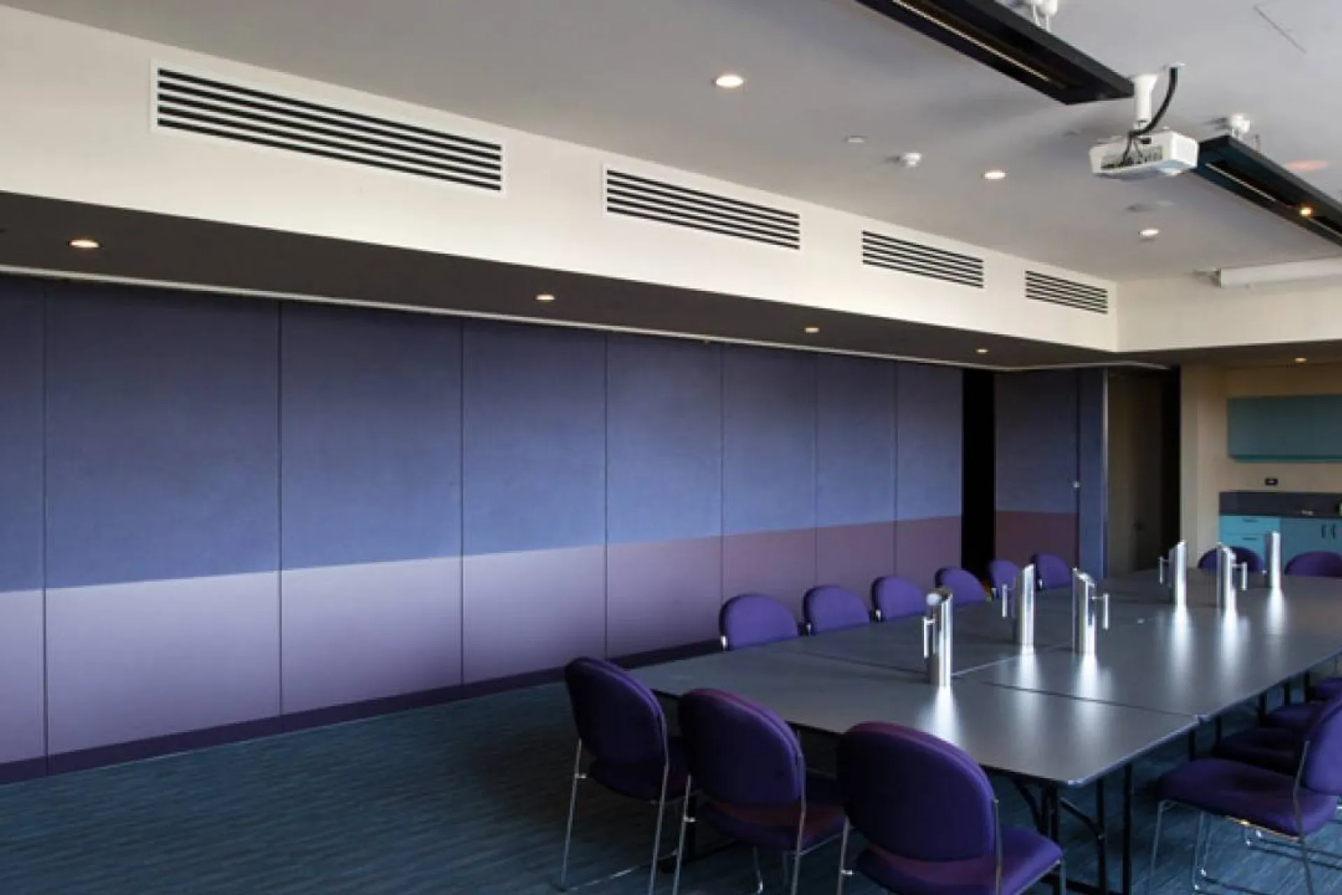 A meeting room with board room table and chairs.