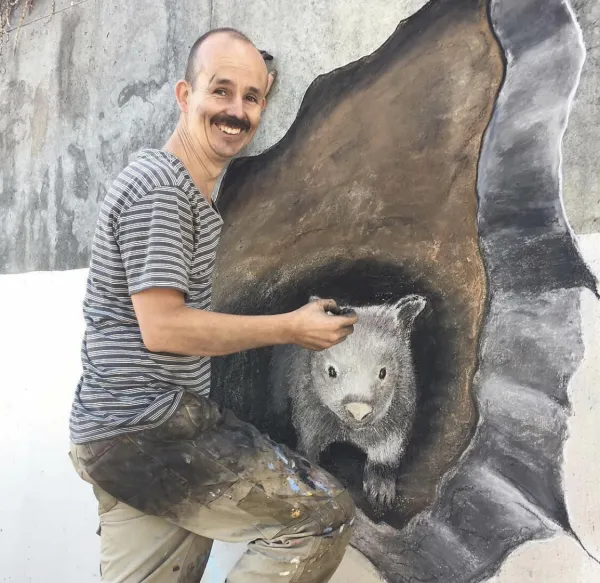 Jimmy with his public mural of a wombat