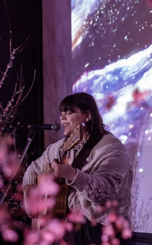 Female performer playing guitar